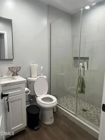 a bathroom with a sink toilet and shower
