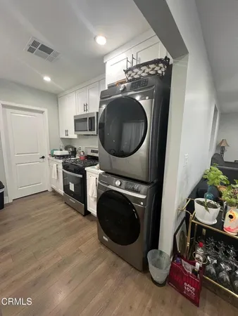 a view of a kitchen with washing machine and sink