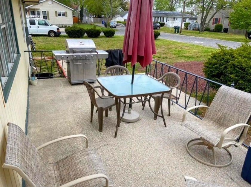 210 South Railroad Avenue Rio Grande, NJ 08242 - Photo 29 of 36 a view of a patio with table and chairs potted plants and a palm tree