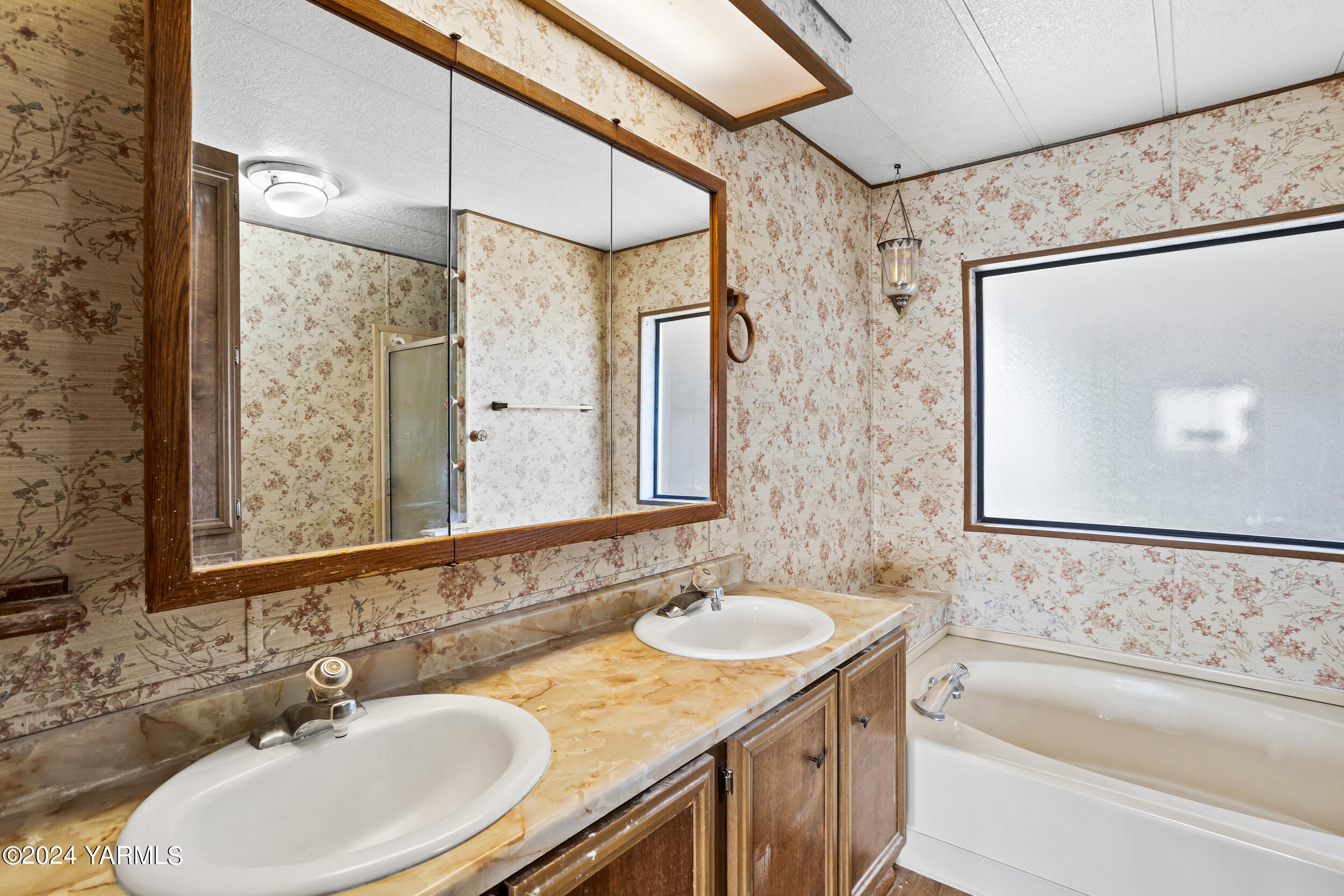 3701 Gun Club Road, Unit 28 Yakima, WA 98901 - Photo 14 of 28 a bathroom with a granite countertop tub sink and mirror