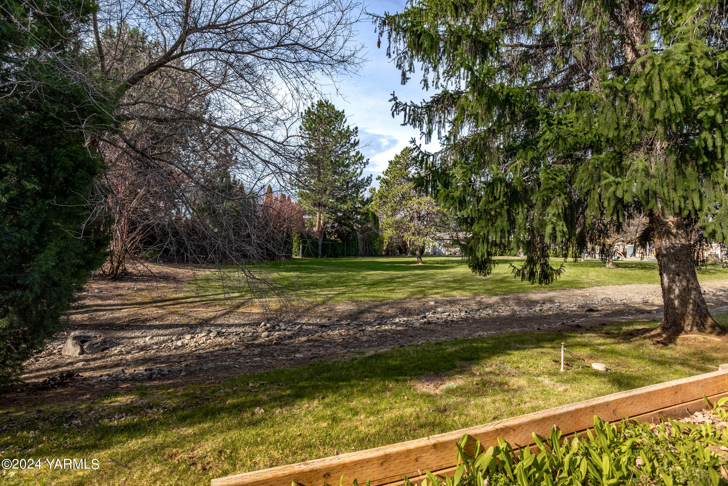 3701 Gun Club Road, Unit 28 Yakima, WA 98901 - Photo 22 of 28 a view of a yard with a large tree