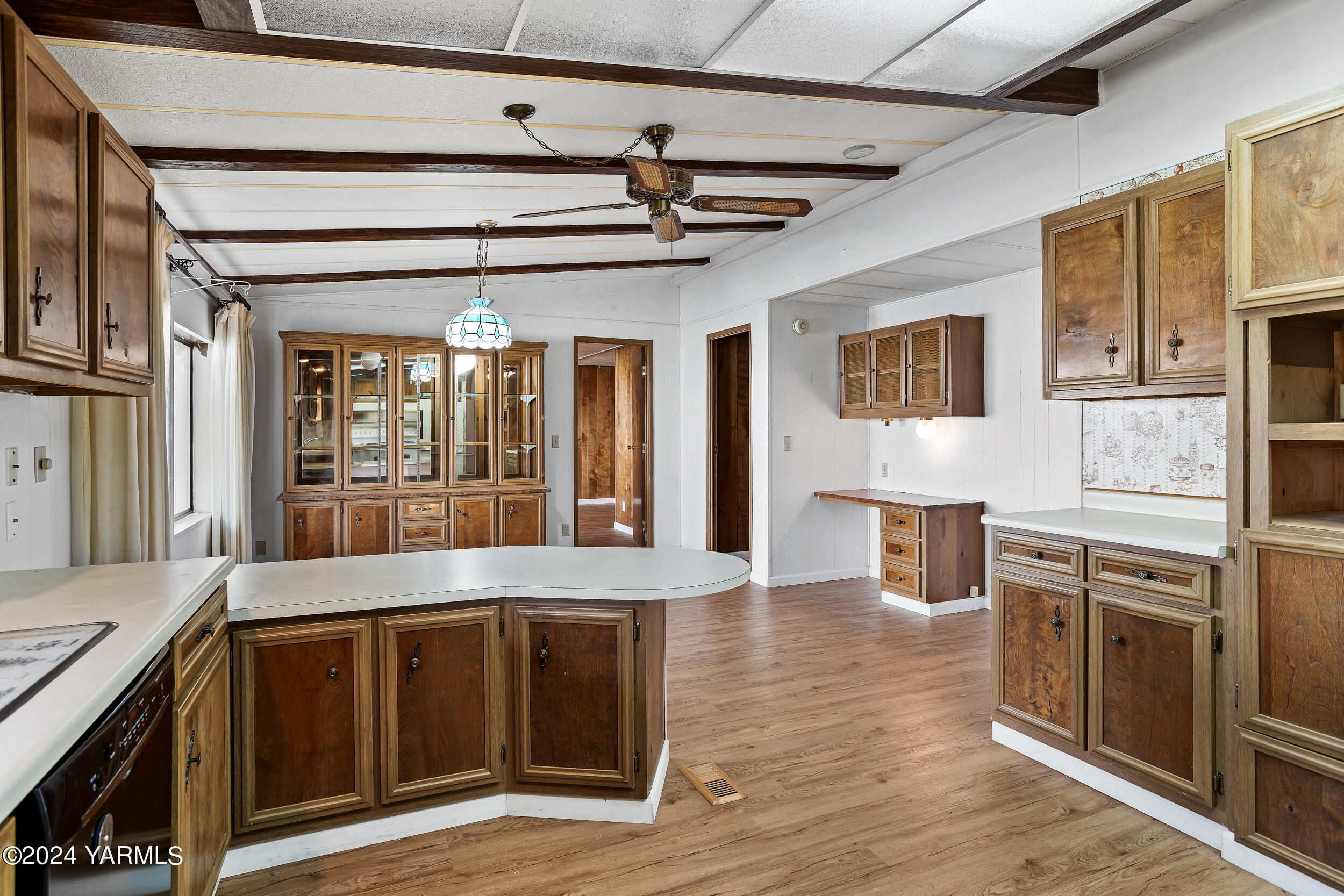 3701 Gun Club Road, Unit 28 Yakima, WA 98901 - Photo 10 of 28 a kitchen with stainless steel appliances granite countertop a stove top oven a refrigerator a sink and dishwasher with wooden floor