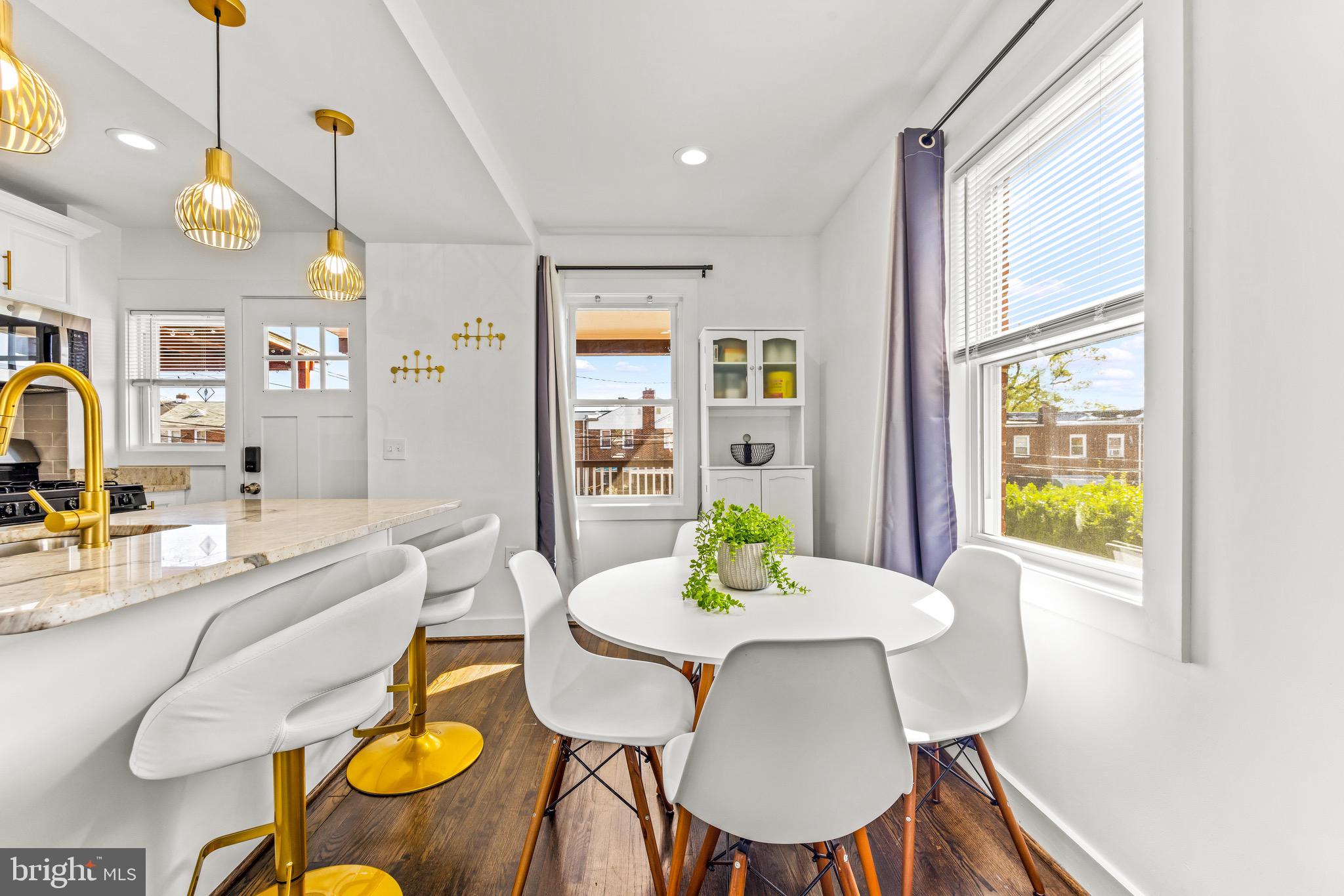 57 Upmanor Road Baltimore, MD 21229 - Photo 11 of 27 a view of a dining room with furniture window and wooden floor