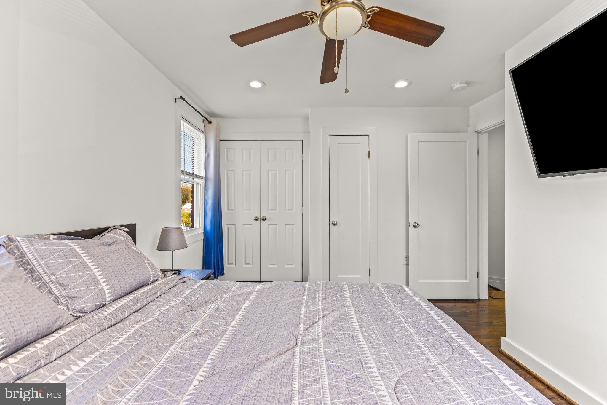 57 Upmanor Road Baltimore, MD 21229 - Photo 14 of 27 a bedroom with a bed and a flat screen tv