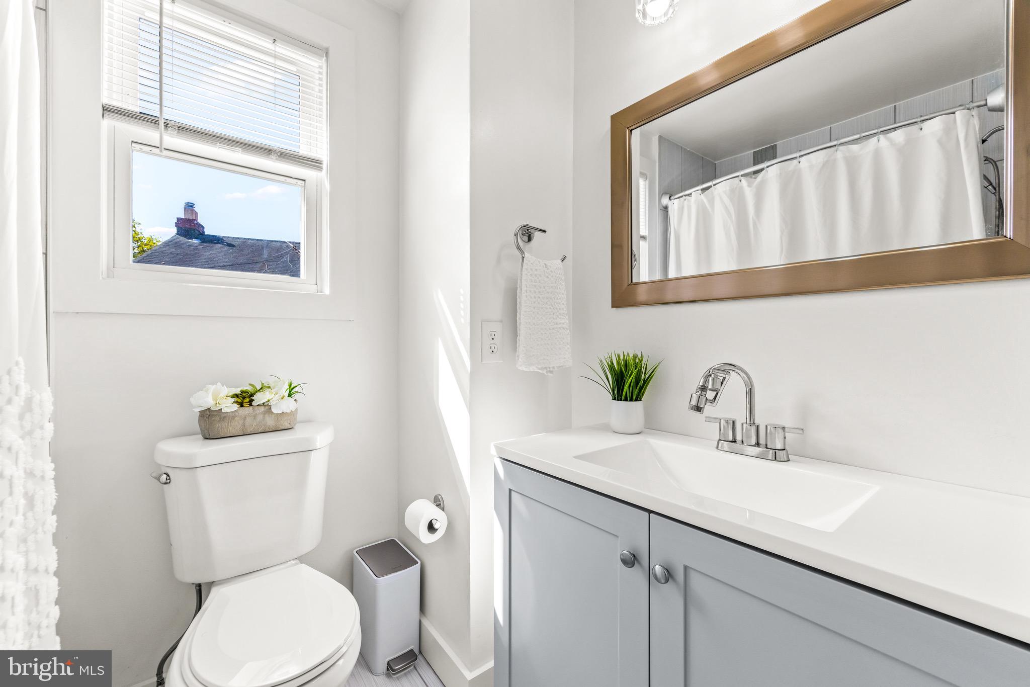 57 Upmanor Road Baltimore, MD 21229 - Photo 15 of 27 a bathroom with a toilet sink and mirror