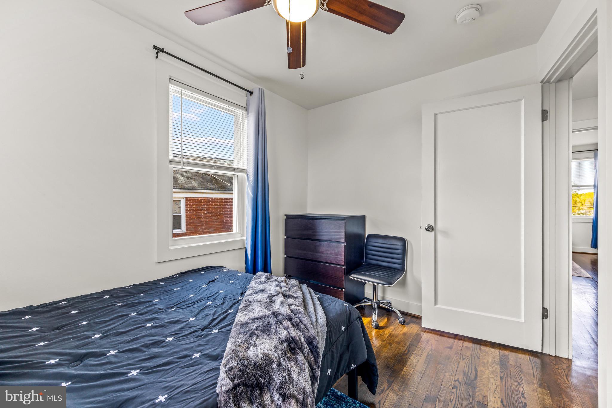 57 Upmanor Road Baltimore, MD 21229 - Photo 18 of 27 a bed sitting in a bedroom next to a window