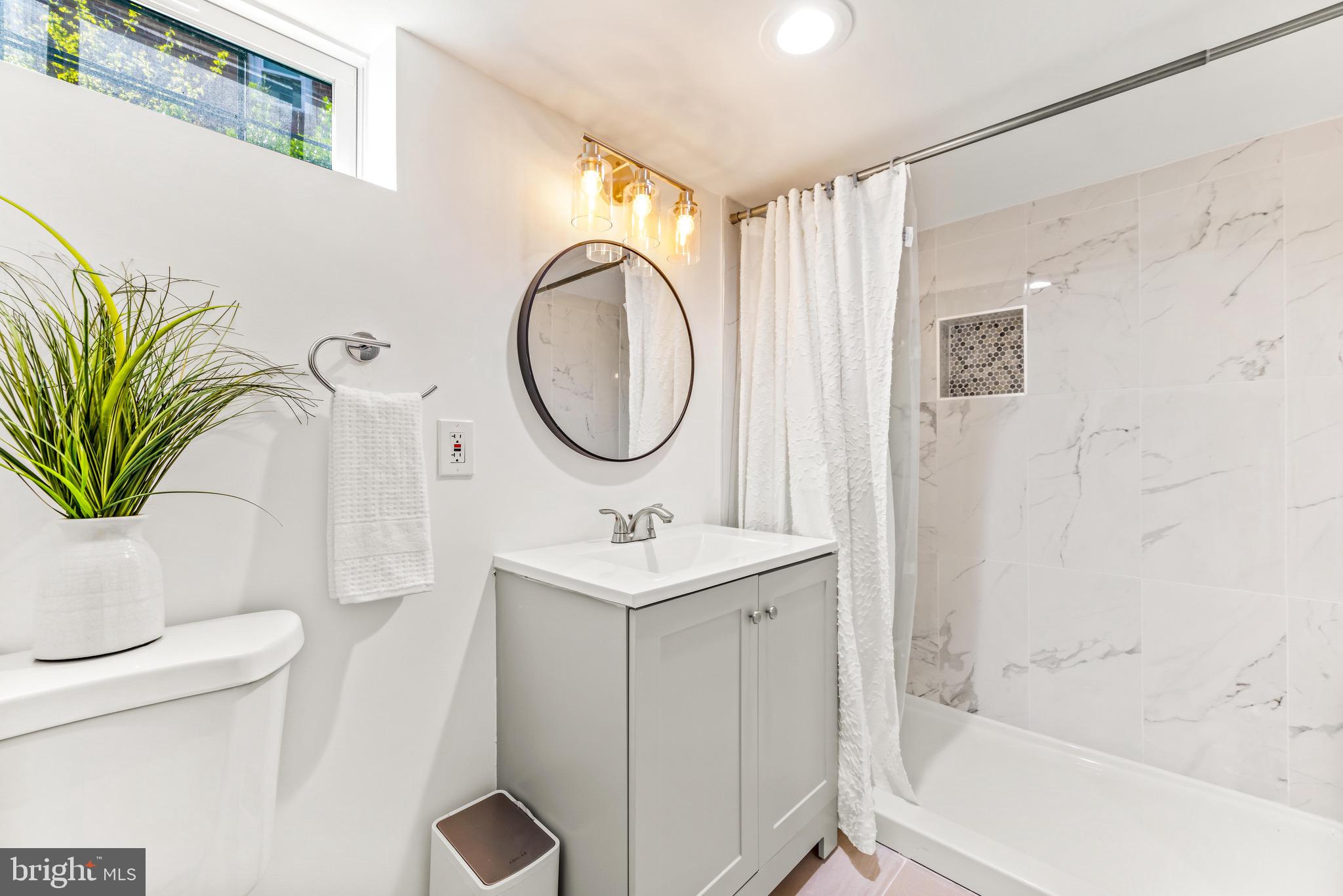 57 Upmanor Road Baltimore, MD 21229 - Photo 22 of 27 a bathroom with a sink a toilet and a mirror