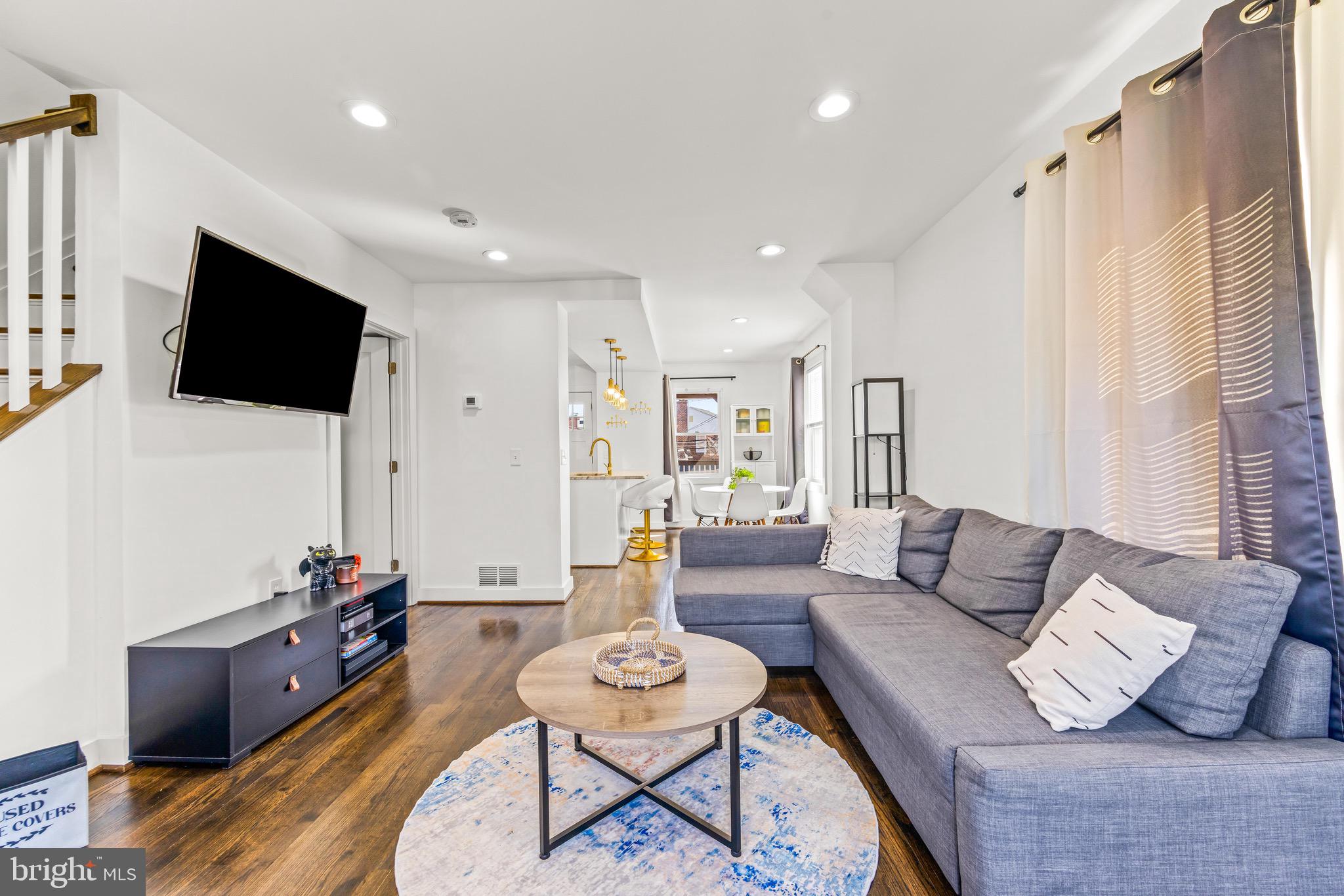 57 Upmanor Road Baltimore, MD 21229 - Photo 3 of 27 a living room with furniture and a flat screen tv