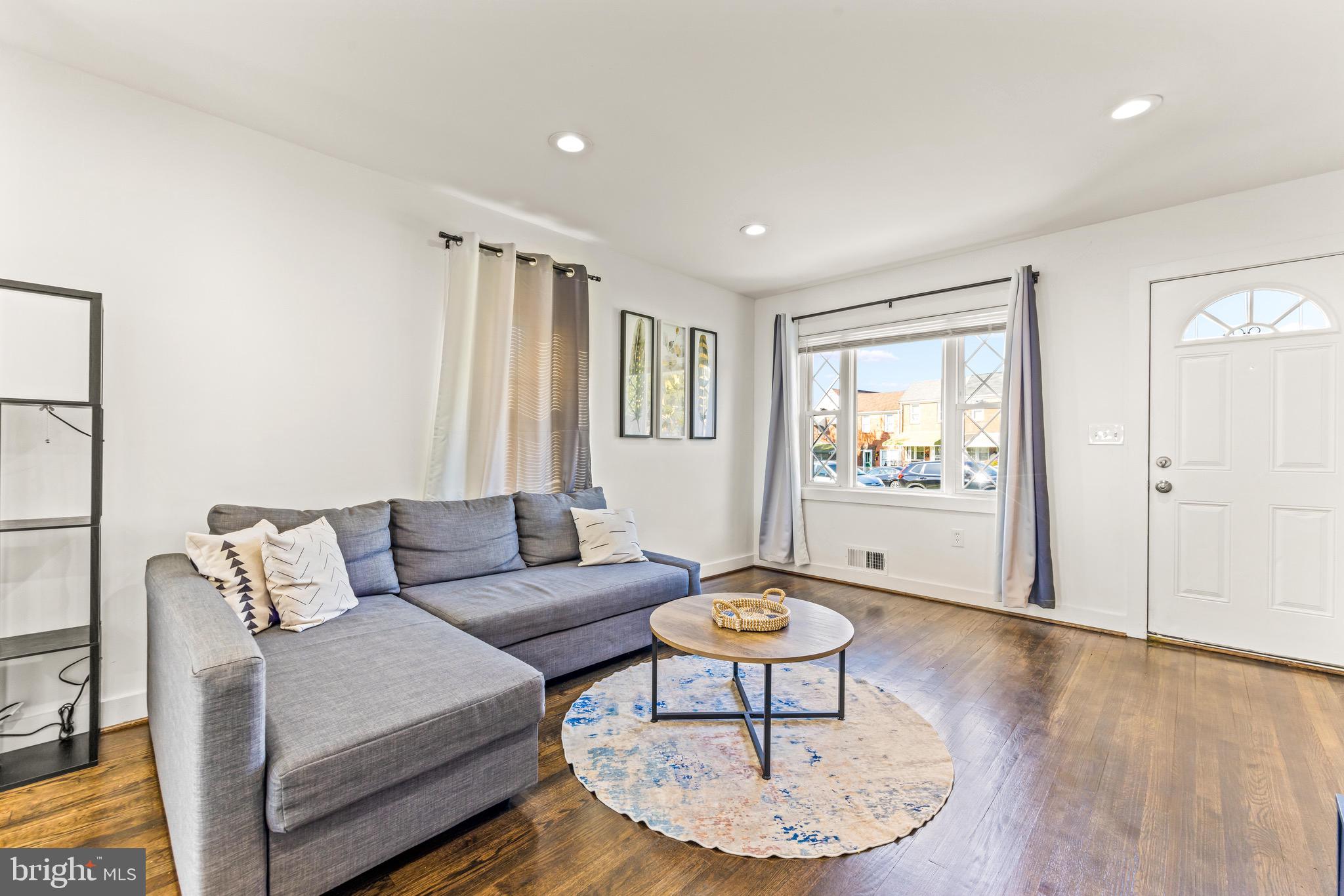 57 Upmanor Road Baltimore, MD 21229 - Photo 4 of 27 a living room with furniture and a wooden floor