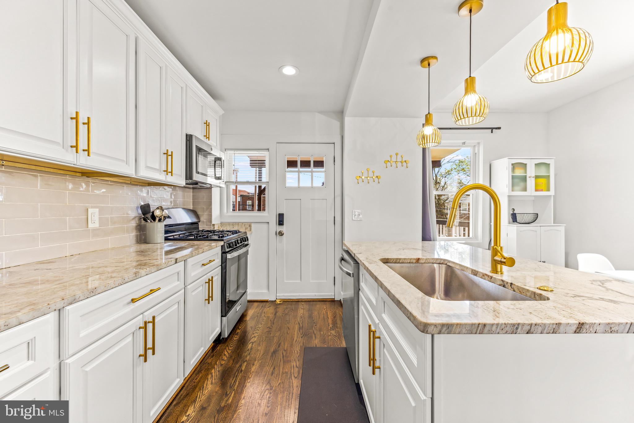 57 Upmanor Road Baltimore, MD 21229 - Photo 7 of 27 a kitchen with granite countertop a sink stove and cabinets