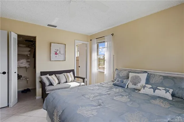 a bedroom with a bed and cabinets