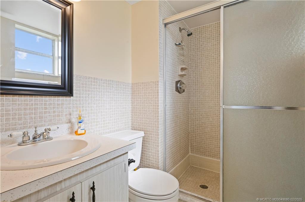 1961 Southwest Palm City Road, Unit F Stuart, FL 34994 - Photo 17 of 29 a bathroom with a sink toilet and shower