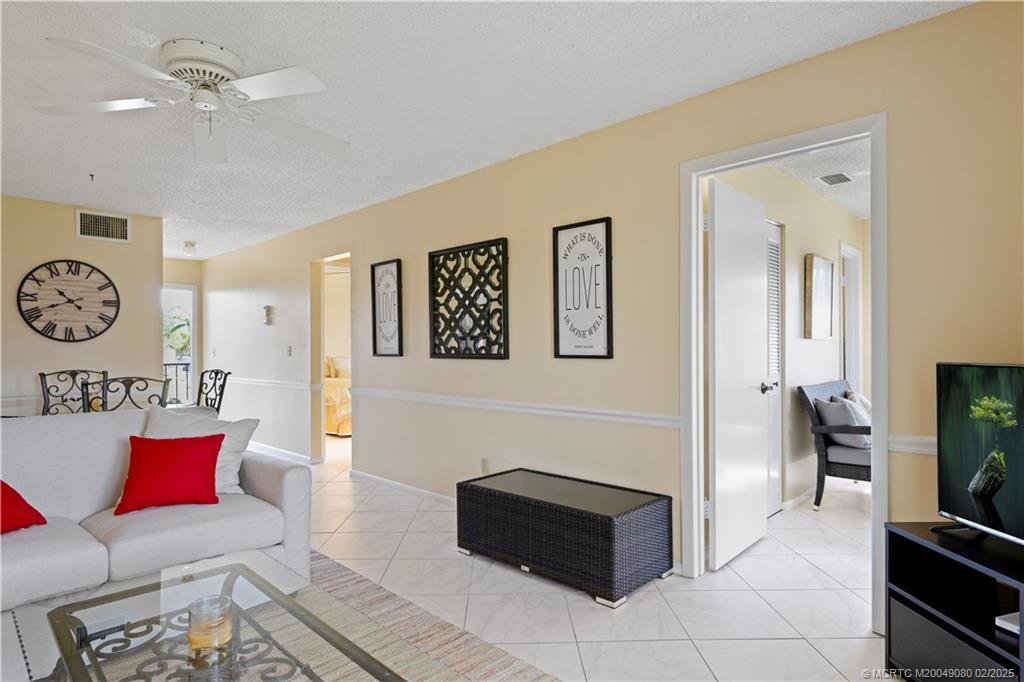 1961 Southwest Palm City Road, Unit F Stuart, FL 34994 - Photo 18 of 29 a living room with furniture and a flat screen tv