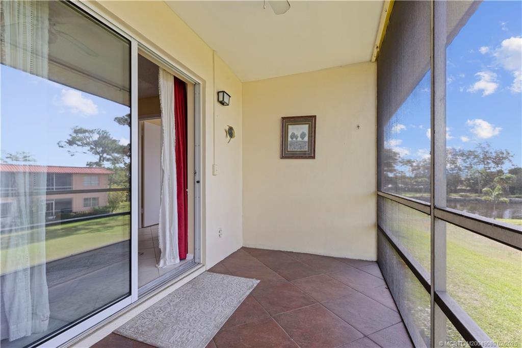 1961 Southwest Palm City Road, Unit F Stuart, FL 34994 - Photo 22 of 29 a view of hallway with a large window and chandelier