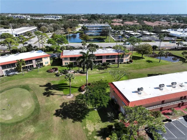 an aerial view of a house with yard swimming pool and outdoor seating