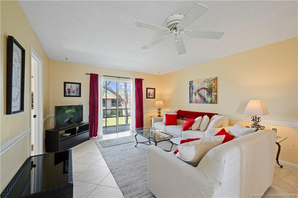 1961 Southwest Palm City Road, Unit F Stuart, FL 34994 - Photo 4 of 29 a living room with furniture and a flat screen tv