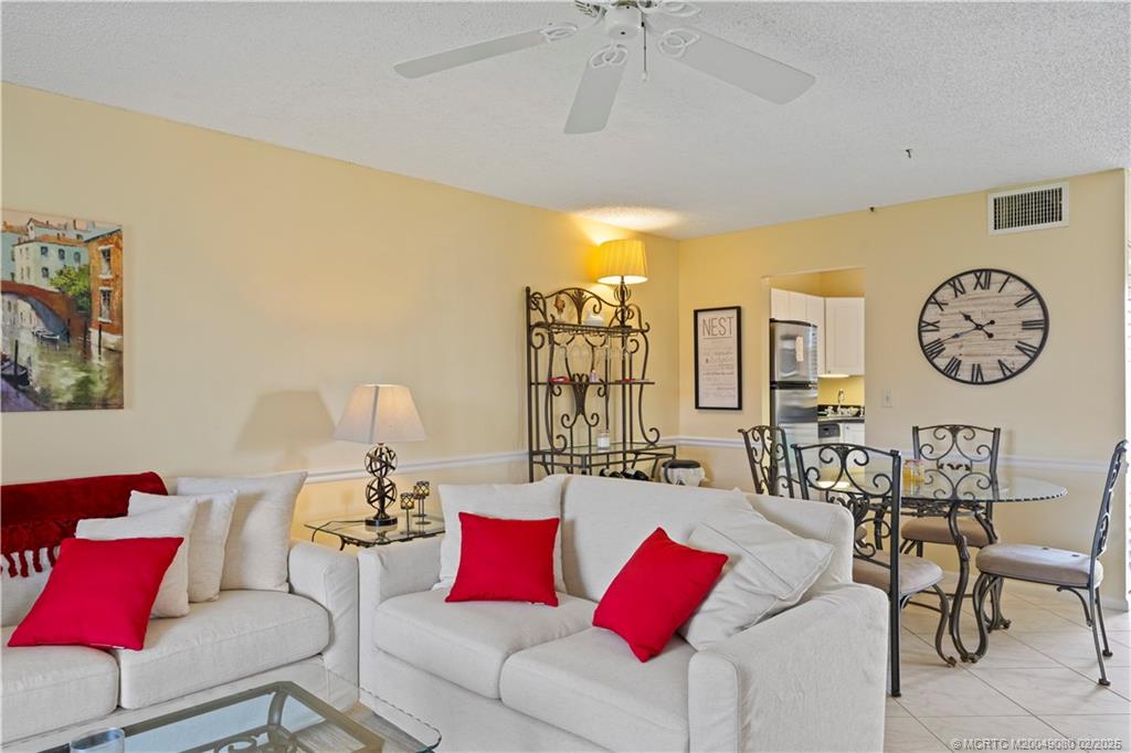 1961 Southwest Palm City Road, Unit F Stuart, FL 34994 - Photo 5 of 29 a living room with furniture and a large window