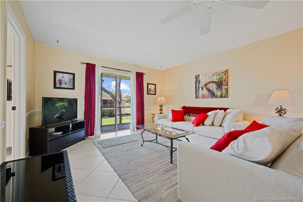 1961 Southwest Palm City Road, Unit F Stuart, FL 34994 - Photo 7 of 29 a living room with furniture and a flat screen tv