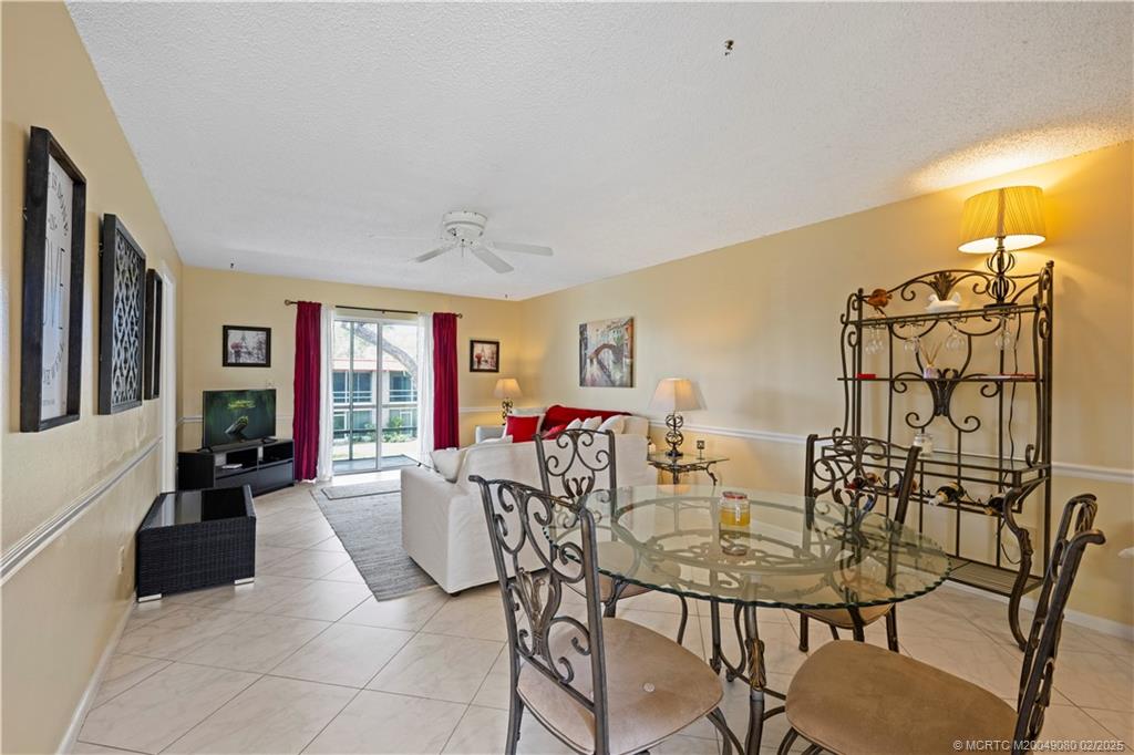 1961 Southwest Palm City Road, Unit F Stuart, FL 34994 - Photo 9 of 29 a view of a dining room with furniture and chandelier