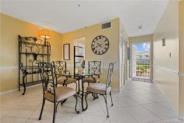 a view of a dining room with furniture and a large window