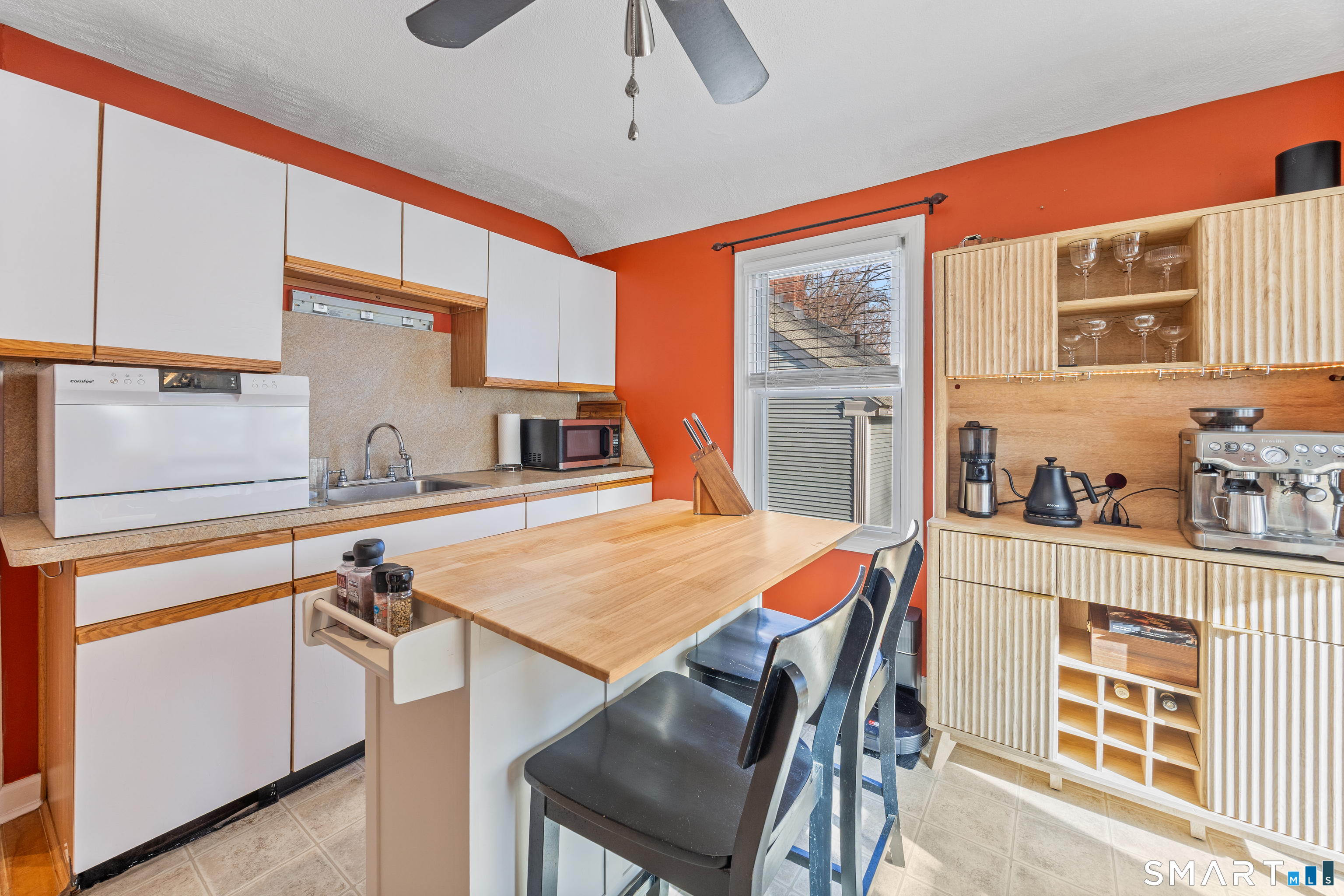 105 Greene Street Bristol, CT 06010 - Photo 9 of 39 a dinning table and chairs in a kitchen