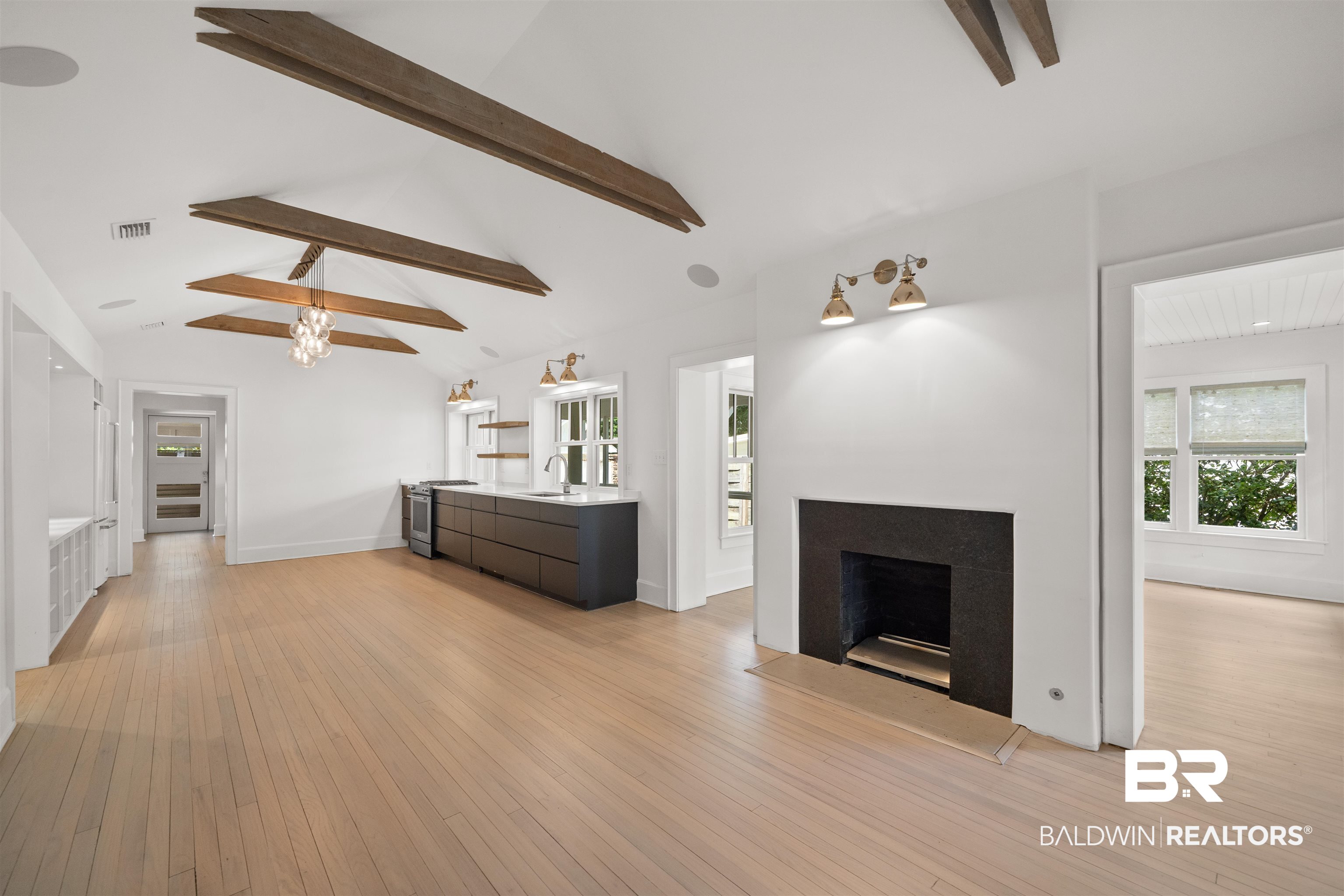 106 White Avenue Fairhope, AL 36532 - Photo 2 of 35 Unfurnished living room featuring light wood-style flooring and a fireplace
