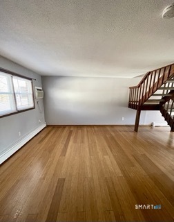 1370 Highland Avenue, Unit 5 Waterbury, CT 06708 - Photo 2 of 15 an empty room with wooden floor and windows