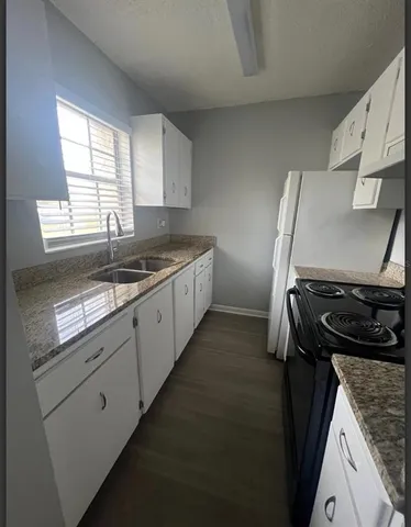 a kitchen with a stove and a sink