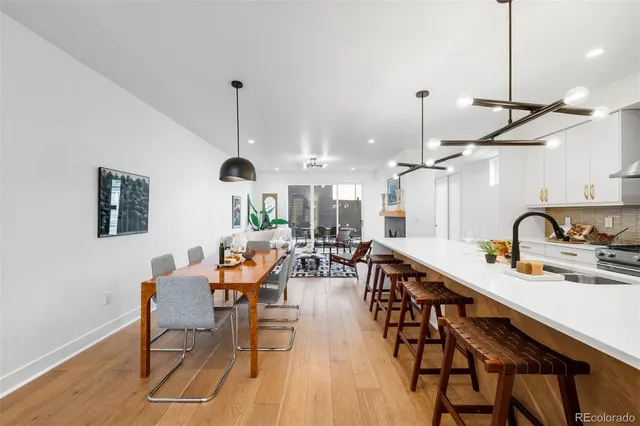 a kitchen that has a sink a stove and cabinets