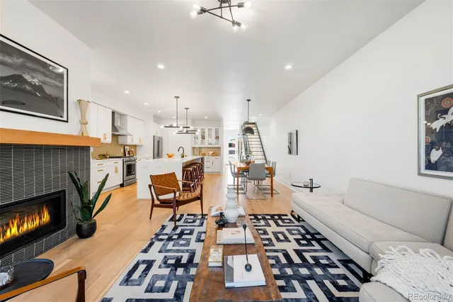 a view of a patio with table and chairs with wooden floor and fence