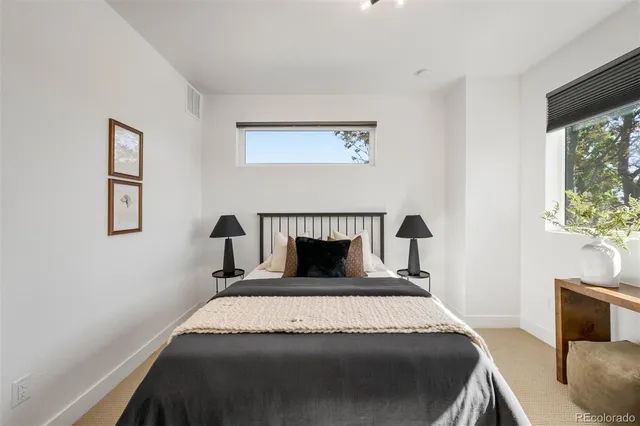 a view of a living room with furniture and floor to ceiling windows