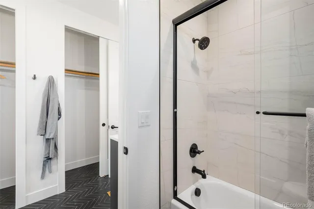 a bathroom with a granite countertop sink a toilet and a mirror