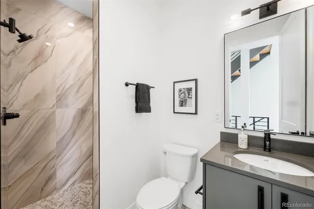 a kitchen with a stove a sink a kitchen island with chairs and wooden floor