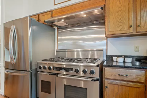 a kitchen with stove and refrigerator