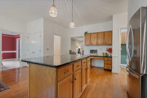 a kitchen with stainless steel appliances granite countertop a sink refrigerator stove and microwave