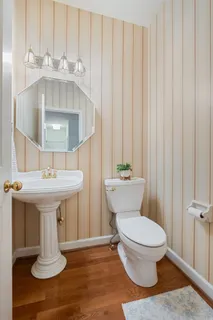 a bathroom with a sink a toilet and a mirror