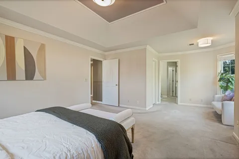 a bedroom with a bed and a potted plant