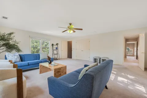 a living room with furniture and a chandelier