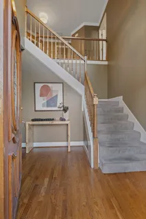 a view of entryway and hall with wooden floor