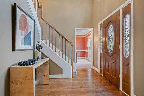 a view of entryway and hall with wooden floor