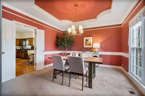 a view of a dining room with furniture and window