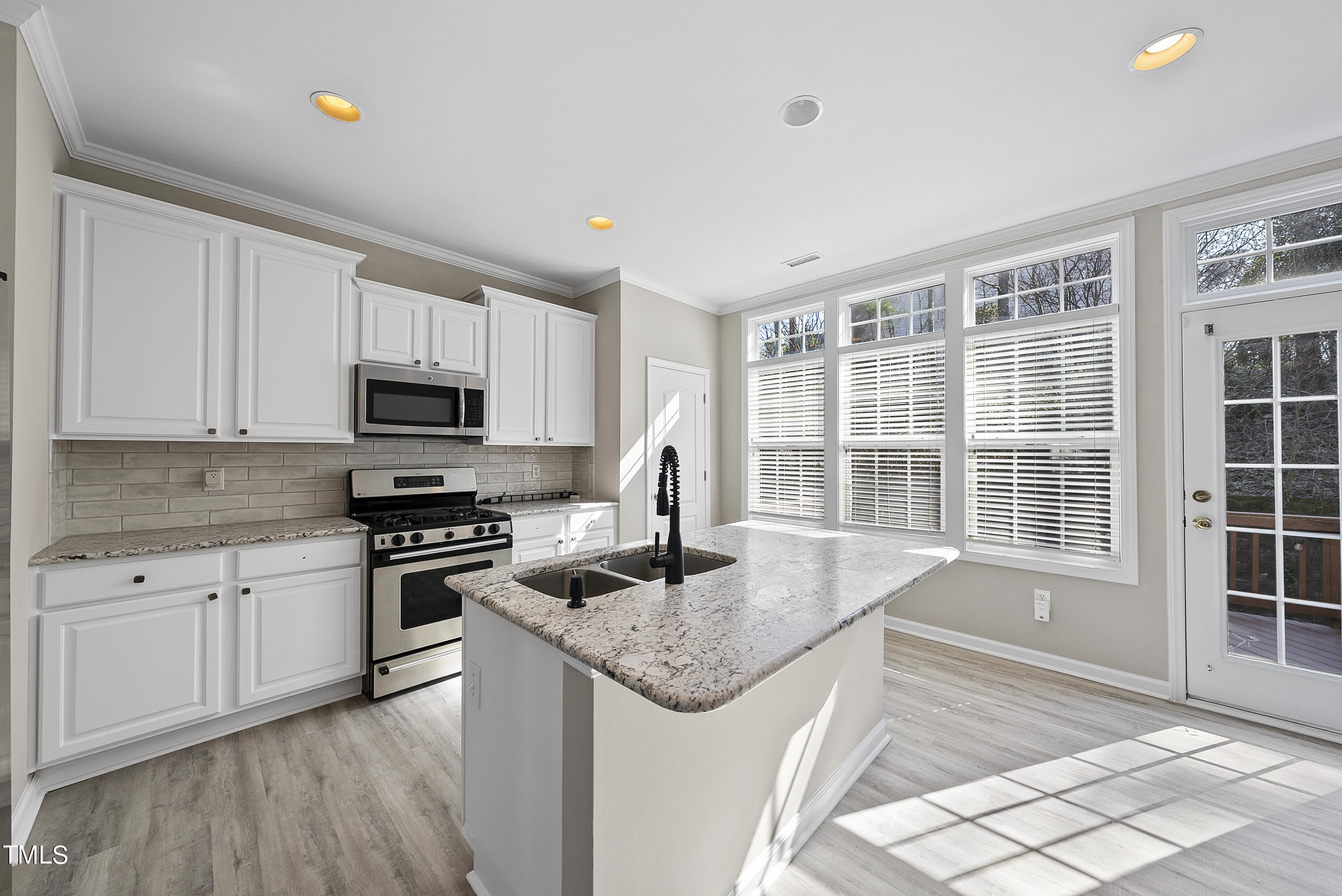 6926 Middleboro Drive Raleigh, NC 27612 - Photo 7 of 29 a kitchen with stainless steel appliances granite countertop a sink stove and cabinets