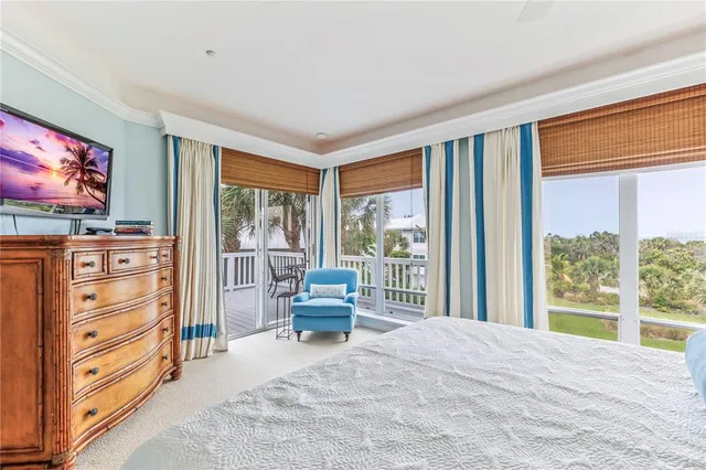 a living room with patio furniture and a floor to ceiling window