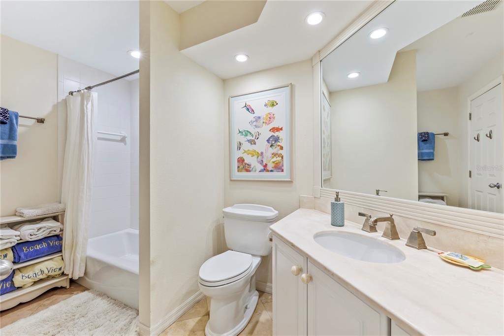 776 Beach View Drive Boca Grande, FL 33921 - Photo 16 of 36 a bathroom with a toilet a sink and a large mirror