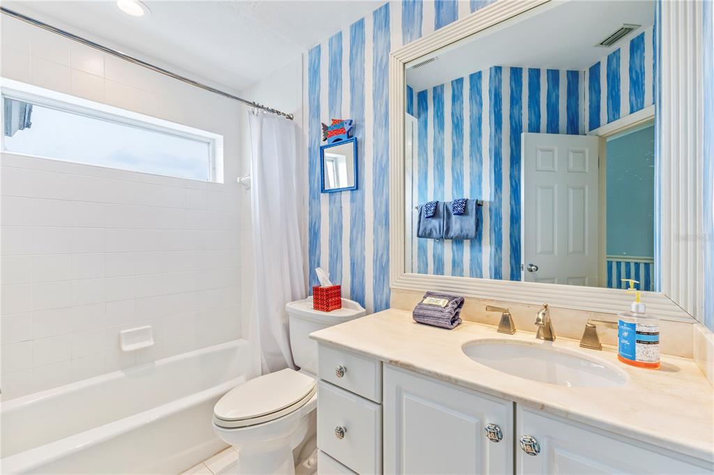 776 Beach View Drive Boca Grande, FL 33921 - Photo 17 of 36 a bathroom with a sink a toilet and a large mirror
