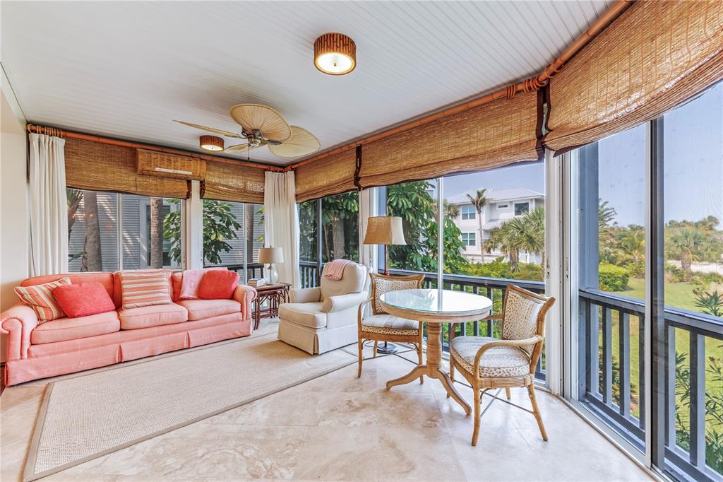 776 Beach View Drive Boca Grande, FL 33921 - Photo 18 of 36 a living room with patio furniture and a floor to ceiling window