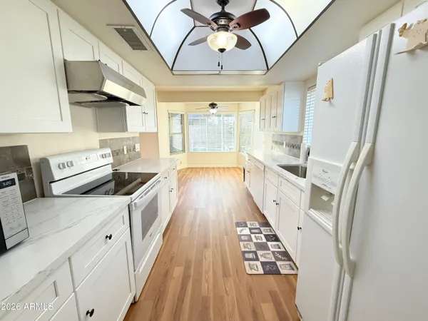 a kitchen with stainless steel appliances a stove a sink and a refrigerator