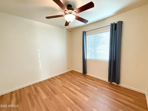 an empty room with fan and a ceiling fan