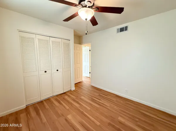 a view of an empty room with wooden floor