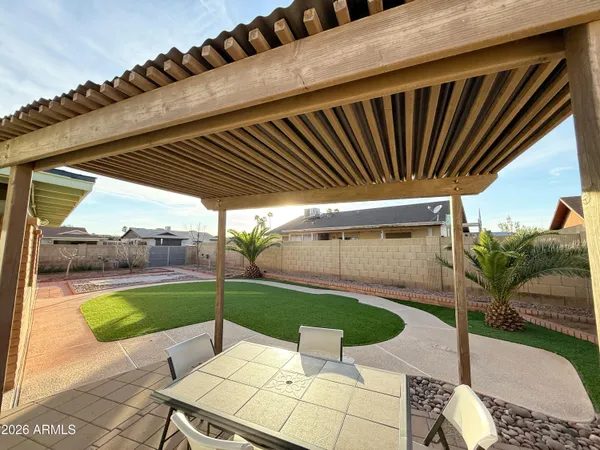 a view of a backyard with sitting area